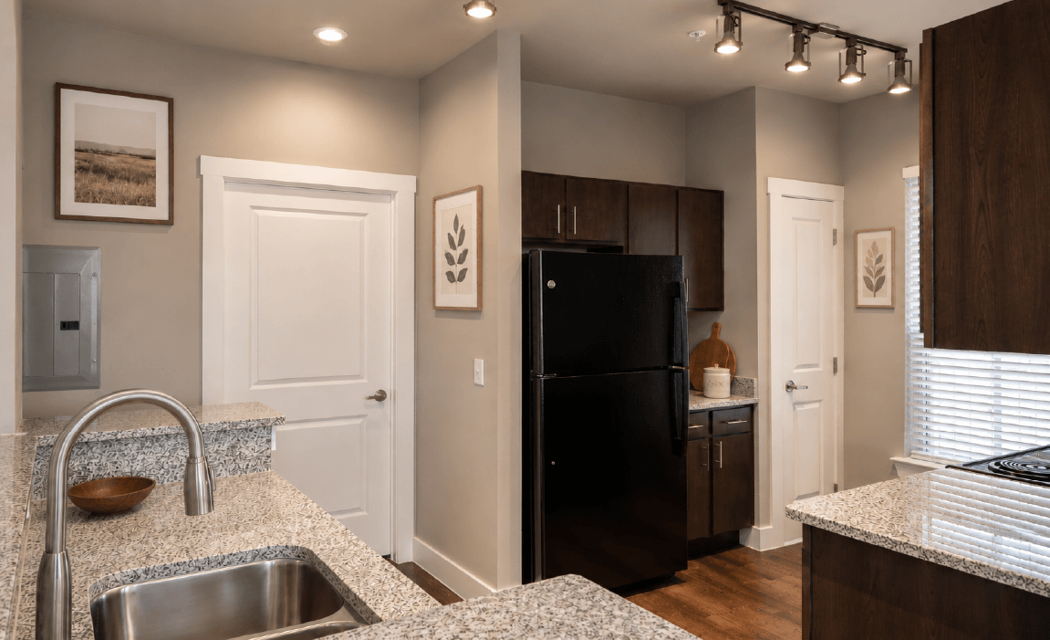 Modern kitchen features with island breakfast bar and black appliance packages in Huntsville